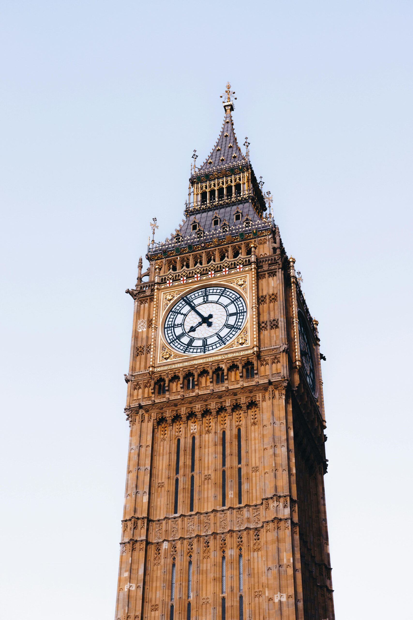 Iconic Big Ben clock tower in London captured during a clear day, showcasing its historic architecture.